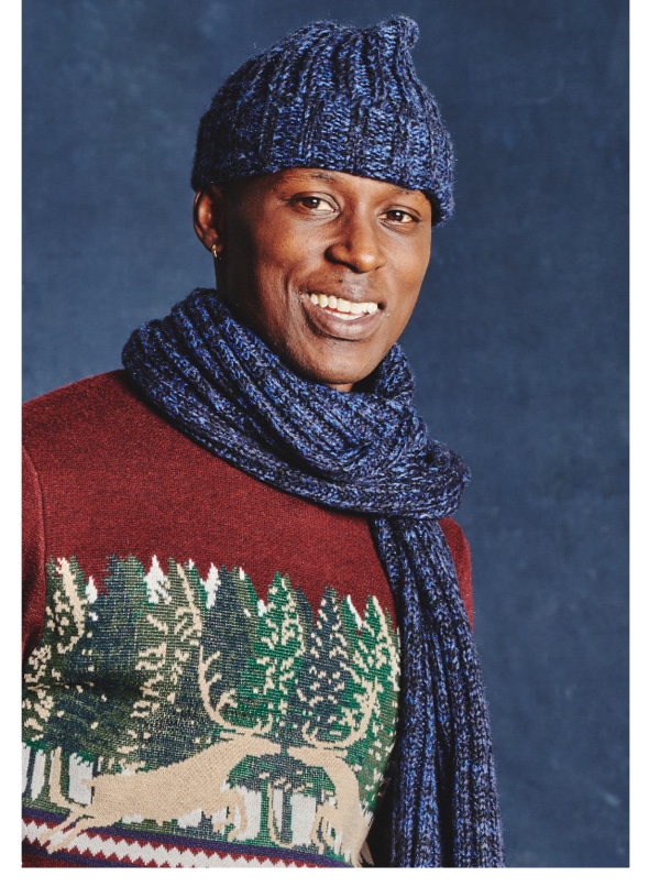 Man wearing sweater scarf and hat
